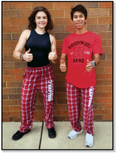 Two people in red and white plaid pants giving thumbs up.