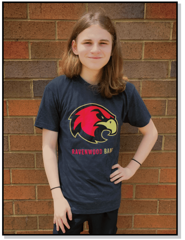 A girl standing in front of a brick wall.