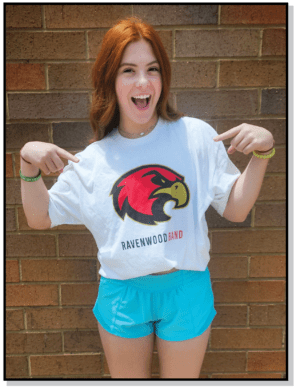 A girl is posing for the camera wearing shorts and a t-shirt.