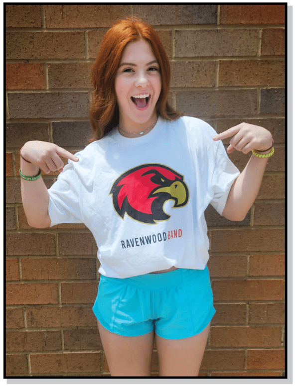 A girl is posing for the camera wearing shorts and a t-shirt.