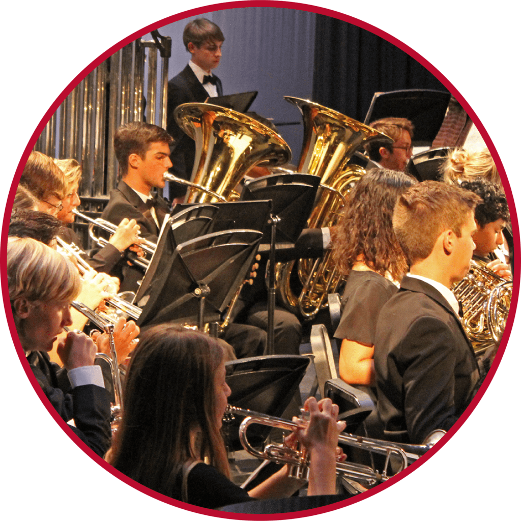 A group of people in black suits playing musical instruments.