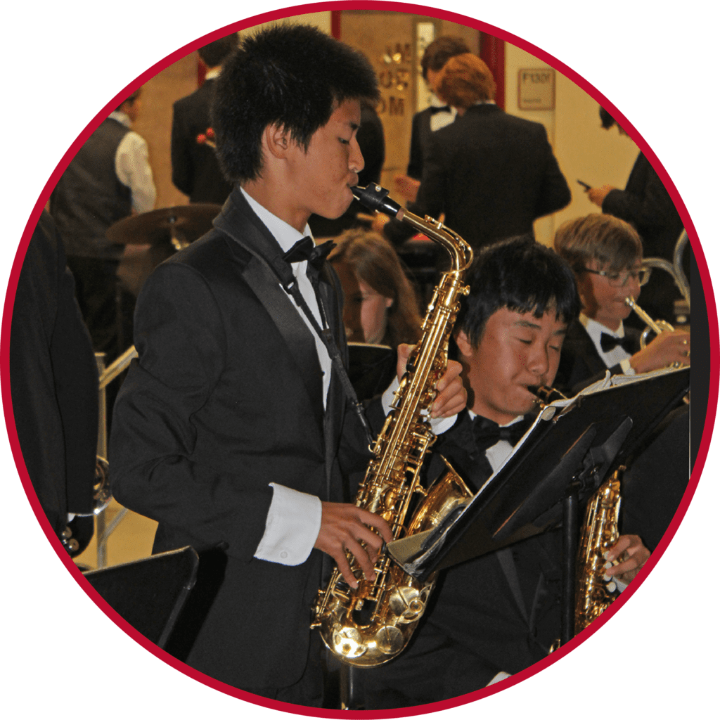 A group of people in suits playing musical instruments.