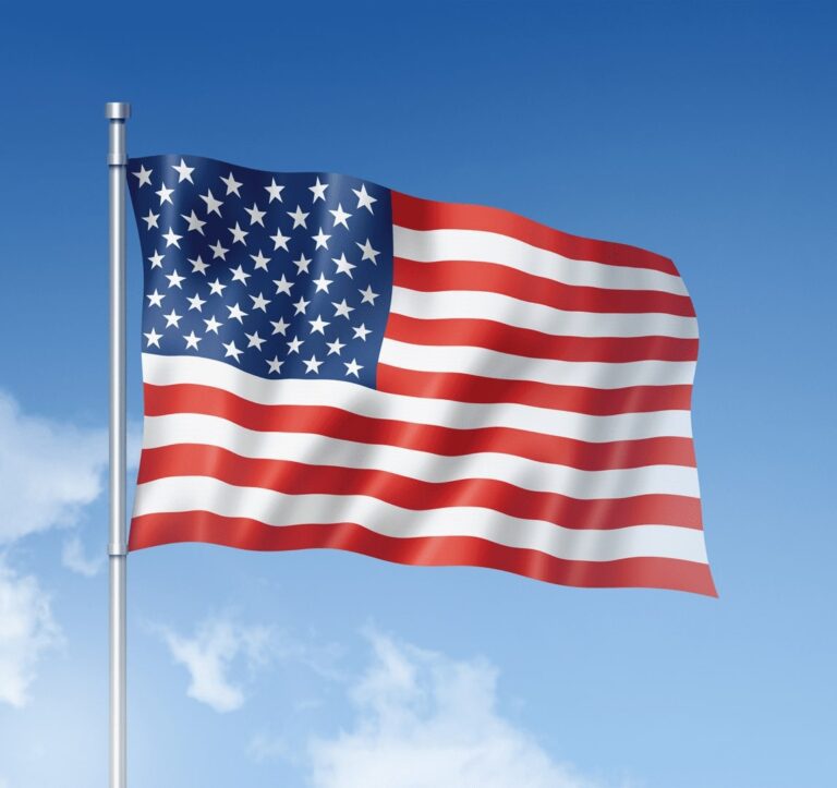 American flag waving in blue sky.